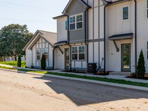 Madison apartment for rent - A two-story house with a grey and white exterior.