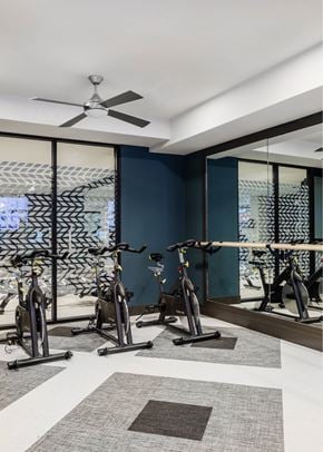 Columbia apartment for rent - A gym with exercise bikes and a fan.
