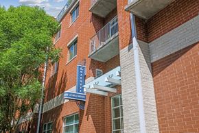 Nashville apartment for rent - A red brick building with a blue sign that says 