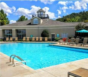 Birmingham apartment for rent - A pool in front of a building with a tower.