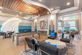 Palm Bay apartment for rent - A room with a pool table and a surfboard on the wall.
