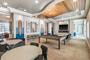 Palm Bay apartment for rent - A modern dining room with a fireplace and a pool table.