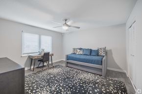 Charleston apartment for rent - A bedroom with a bed, desk, and chair.