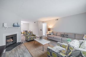 Charleston apartment for rent - A living room with a fireplace and a grey couch.