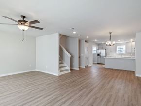 Chattanooga apartment for rent - A spacious room with a ceiling fan and wooden flooring.