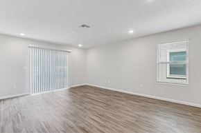 Jacksonville apartment for rent - A room with wooden flooring and a window with blinds.