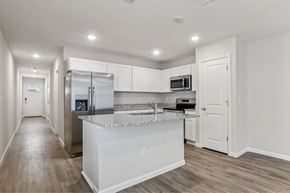 Jacksonville apartment for rent - A kitchen with white cabinets and a stainless steel refrigerator.