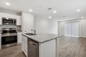 Jacksonville apartment for rent - A kitchen with white cabinets and a granite countertop.