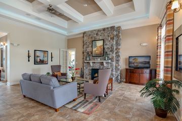 Smyrna apartment for rent - A living room with a grey couch, a fireplace, and a painting on the wall.