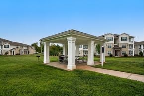 Smyrna apartment for rent - A white gazebo is in the middle of a grassy area with houses in the background.