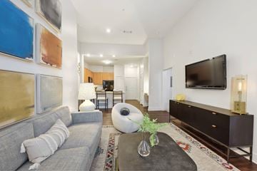 Nashville apartment for rent - A living room with a grey couch and a large painting on the wall.