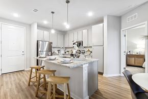Palm Bay apartment for rent - A kitchen with a white counter top and wooden bar stools.