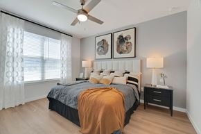 Charlotte apartment for rent - a bedroom with a bed and a ceiling fan