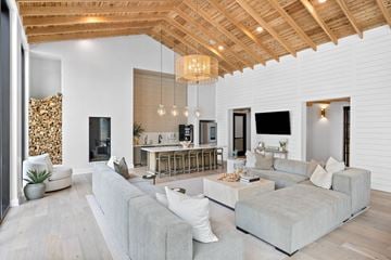 Murrells Inlet apartment for rent - A modern living room with a grey sofa and a wooden ceiling.