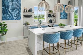 Port St. Lucie apartment for rent - A kitchen with a white counter and blue chairs.
