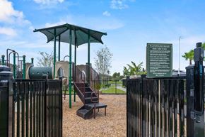 Port St. Lucie apartment for rent - A playground with a green canopy and a sign that reads 