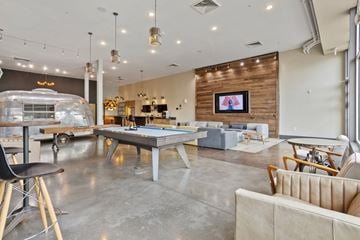 Nashville apartment for rent - A modern living room with a pool table and a bar area.