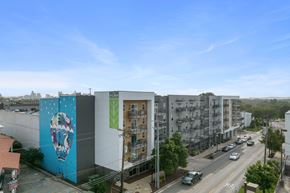 Nashville apartment for rent - A street view of a city with cars and buildings.