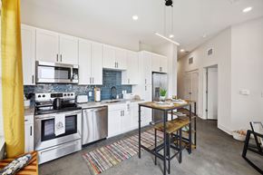 Huntsville apartment for rent - A modern kitchen with a dining table and chairs.