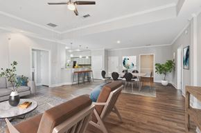 Canton apartment for rent - A living room with a brown sofa and a wooden floor.