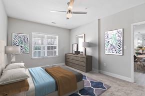 Canton apartment for rent - A bedroom with a bed, dresser, and ceiling fan.
