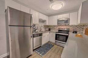 Decatur apartment for rent - A kitchen with a stainless steel refrigerator and a stone backsplash.