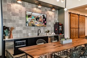 Miami apartment for rent - A modern kitchen with a wooden table and chairs.