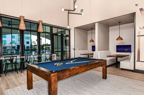Miami apartment for rent - A pool table in a room with a view of the outside.