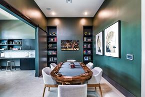 Miami apartment for rent - A modern dining room with a wooden table surrounded by white chairs.