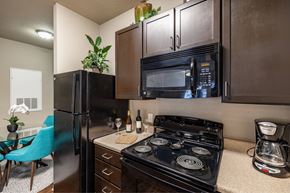 Lakeland apartment for rent - Big oaks apartments lakeland florida model kitchen with black appliances and wooden cabinets