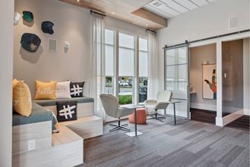 Nashville apartment for rent - A living room with a sofa, chairs, and a painting on the wall.