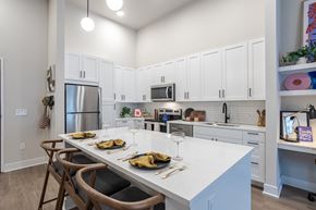 Nashville apartment for rent - A kitchen with a table set for two with a white counter top.