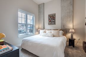 Nashville apartment for rent - A bedroom with a large bed and a painting on the wall.