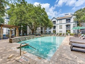 Houston apartment for rent - A pool surrounded by trees and chairs with a sign that says no diving.