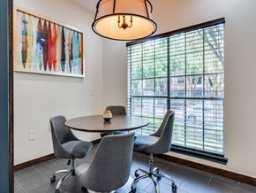 Houston apartment for rent - A dining room with a table and chairs and a painting on the wall.
