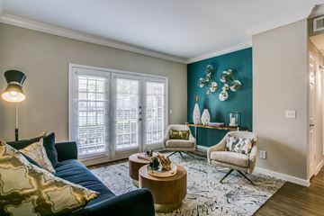 Houston apartment for rent - A living room with a blue couch and a coffee table.