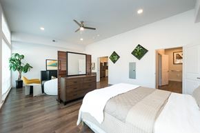 Dallas apartment for rent - A bedroom with a large bed and a dresser.