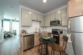 Dallas apartment for rent - A modern kitchen with a table and chairs.