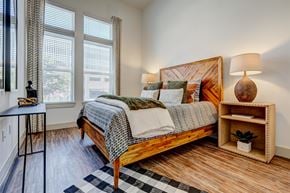 Mckinney apartment for rent - a bedroom with a bed and two windows