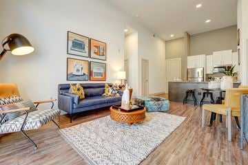 Mckinney apartment for rent - A living room with a blue couch and a coffee table.