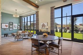 Mckinney apartment for rent - a large living room with large windows and a table and chairs