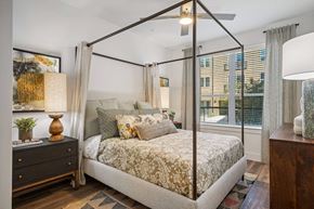 Mckinney apartment for rent - a bedroom with a canopy bed and a window