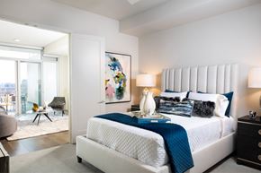Frisco apartment for rent - A bedroom with a large bed and a painting on the wall.