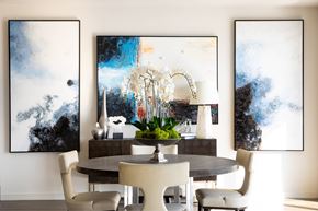 Frisco apartment for rent - A dining room with a table and chairs and two paintings on the wall.