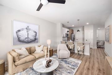 Wilmington apartment for rent - A living room with a couch, a coffee table, and a painting of a ship on the wall.
