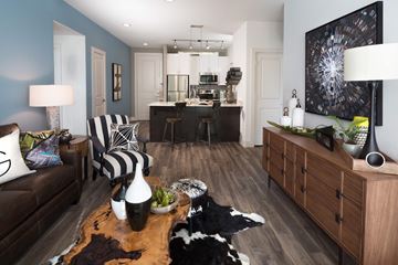 Dallas apartment for rent - A living room with a cowhide rug and a black and white striped chair.