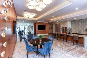 Dallas apartment for rent - A modern dining room with a round table and blue chairs.