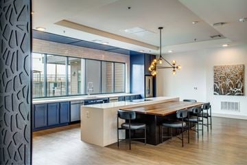 Denton apartment for rent - A modern kitchen with a wooden table and chairs.