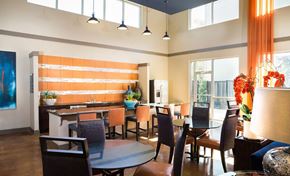 Dallas apartment for rent - A modern dining room with a wooden table and chairs.