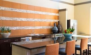 Dallas apartment for rent - A kitchen with a counter and chairs.
